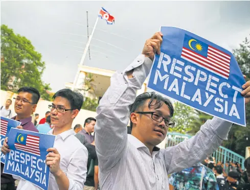  ??  ?? DETERIORAT­ING RELATIONS: Members of the youth wing of the National Front hold placards during a protest outside the North Korean embassy in Kuala Lumpur.