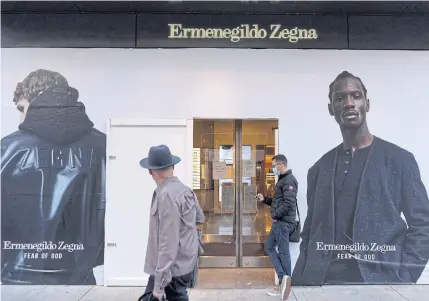  ?? REUTERS ?? Plywood covers the windows of an Ermenegild­o Zegna store in Chicago, Illinois on October 13, 2020 during the outbreak of coronaviru­s.