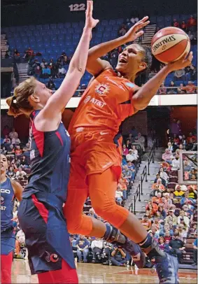  ?? SEAN D. ELLIOT/THE DAY ?? Connecticu­t Sun forward Alyssa Thomas, right, puts up a shot as Washington Mystics center Emma Meesseman defends in Saturday’s WNBA game at Mohegan Sun Arena.