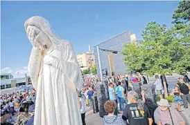  ??  ?? Faith leaders and others meet Monday at the “Jesus Wept” statue to take part in the prayer walk and service.