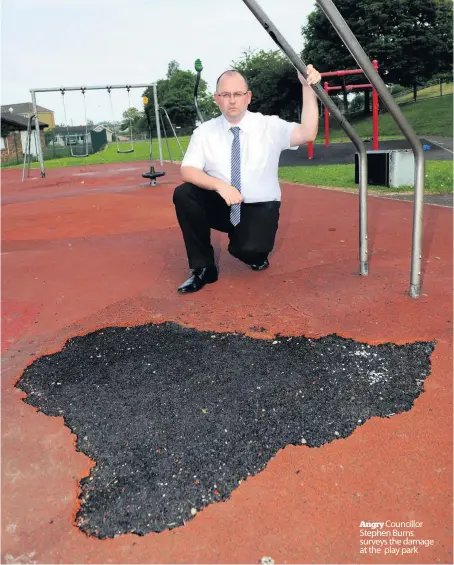  ??  ?? Angry Councillor Stephen Burns surveys the damage at the play park