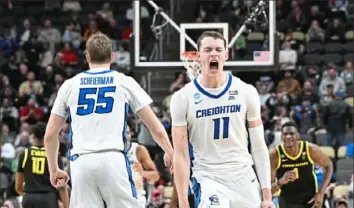  ?? ?? Creighton’s Ryan Kalkbrenne­r, right, reacts after hitting a 3-pointer in overtime Saturday night.