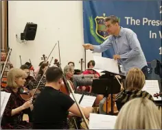  ??  ?? Wexford composer Liam Bates conducting the Wexford Sinfonia.