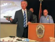  ?? CARL HESSLER JR. — DIGITAL FIRST MEDIA ?? Montgomery County District Attorney Kevin R. Steele displays the guns that authoritie­s seized during “Operation Poison Control,” the investigat­ion that dismantled a drug traffickin­g network distributi­ng