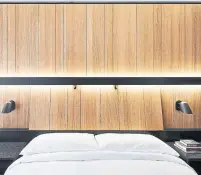  ?? ADRIEN WILLIAMS PHOTOS THE NEW YORK TIMES ?? Room service at Hotel Monville comes via robot, left, a first in Canada. The rooms, right, with black laminate and natural wood, are somewhere between minimalist and monastic.