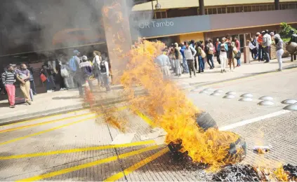  ?? Picture: Jacques Nelles ?? FIERY PROTEST. A tyre burns while Unisa students protest at the main campus yesterday during a shutdown a week before their exams.