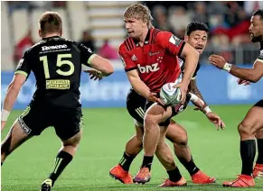  ?? MARK BAKER ?? Jack Goodhue was one of several Crusaders cutting the Hurricanes defence to shreds in the first half of the Super Rugby match in Christchur­ch on Saturday night.