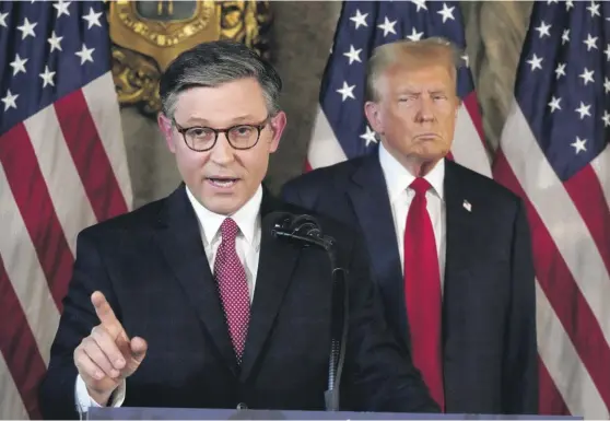  ?? WILFREDO LEE/AP ?? Speaker of the House Mike Johnson, R-La., speaks as former President Donald Trump looks on during a news conference April 12 at Mar-a-Lago.