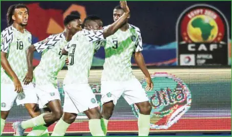  ??  ?? L-R: Alex Iwobi, Wilfred Ndidi, Oghenekaro Etebo and Jamilu Collins celebratin­g Nigeria’s bronze at the last AFCON 2019 in Egypt. Nigeria defeated Benin Republic 2-1 yesterday to start the AFCON 2021 qualifiers with maximum points