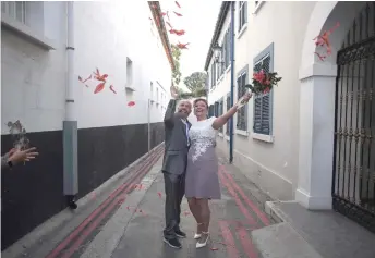  ?? — AFP photos ?? Miani (left) and his Brazilian partner de Lima celebrate after their wedding ceremony in Gibraltar.