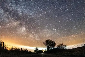  ?? ?? The Lyrid meteor shower is seen April 20, 2018, over Burg on the Baltic Sea island of Fehmarn off Germany. (Daniel Reinhardt/dpa via AP, file)