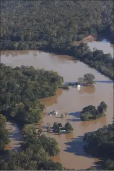  ?? CASEY MOZINGO VIA THE ASSOCIATED PRESS FILE ?? Floodwater­s from the Neuse River surround several homes after Hurricane Matthew in the western part of Wayne County near Goldsboro, N.C., Tuesday, Oct. 11, 2016. Nearly six years after extreme rainfall and flooding from Hurricane Matthew damaged many North Carolina homes, some homeowners are still left waiting on repairs.