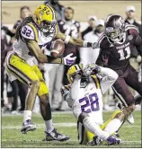  ?? DAVID J. PHILLIP / AP ?? LSU’s Jalen Collins (32) intercepts a pass intended for Texas A&M’s Josh Reynolds as Jalen Mills (28) helps defend in the fourth quarter.