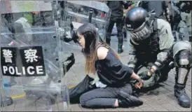  ?? REUTERS ?? A policeman detains a protester during one of the anti-government demonstrat­ions in central Hong Kong on Sunday night.