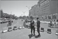  ?? AP/VAHID SALEMI ?? Police officers stand guard Thursday in front of Iran’s parliament building in Tehran.