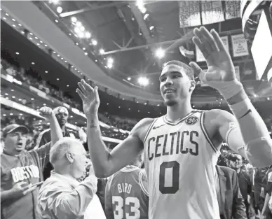  ??  ?? Boston Celtics forward Jayson Tatum (0) walks off of the court after the Celtics defeated the Philadelph­ia 76ers in Game 5 of the second round of the NBA Playoffs at the TD Garden on Wednesday in Boston.