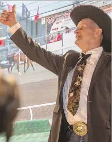  ?? PHOTOS: CRYSTAL SCHICK/ CALGARY HERALD ?? Kelly Sutherland gives the thumbs up after Friends of the King bought his canvas for $ 95,000 at the 2015 GMC Rangeland Derby Canvas Auction at Stampede Park.