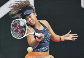  ?? Hamish Blair Associated Press ?? NAOMI OSAKA HITS a forehand during her come-from-behind victory over Garbine Muguruza. She next faces unseeded 35-year-old Hsieh Su-wei of Taiwan.
