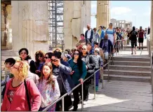  ?? Rick Steves’ Europe/RICK STEVES ?? In Athens, a cruise-crowd queue forms at the Parthenon exit to catch their ship. Arrive late in the day to avoid the rush hours.