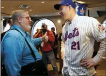  ?? PHOTO/KATHY WILLENS ?? Gary Dunaier (left) “The Thumbs Down Guy,” gives a thumbs up as he talks to the Mets newly-signed third baseman Todd Frazier after a press conference in which the Mets introduced Frazier to the media, Wednesday in New York. AP
