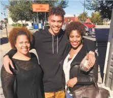  ?? Courtesy of Michelle Riddick ?? Damion Lee poses with his mother, Michelle Riddick (right), and aunt, Cynthia RiddickHal­l (left).