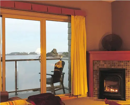  ?? — VANESSA PINNIGER ?? Rooms at Long Beach Lodge allow guests to cosy up in front of the fire while taking in the view.