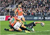  ??  ?? On their way: Zach Mercer extends a long arm to score the first try for Bath in their battling defeat of Treviso at the Recreation Ground yesterday