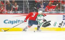  ?? GEOFF BURKE/USA TODAY ?? The Capitals’ Nick Jensen checks the Dallas Stars’ Jamie Benn earlier this month. Washington has three players in the NHL’S top 20 in hits: Alex Ovechkin, Tom Wilson and Garnet Hathaway.