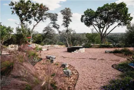  ?? Josie Norris/staff photograph­er ?? In the back, a large fire pit will be surrounded by small rock. The different rocks in the landscape add color and texture.