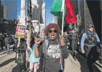  ?? | ASHLEE REZIN/ SUN- TIMES ?? Carolyn J. Ruff, 70, of the Lake View neighborho­od protests on the Mag Mile on Friday. See more photos online at suntimes. com.