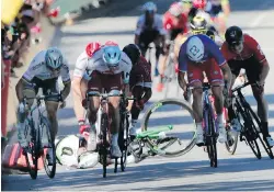  ?? CHRISTOPHE ENA, THE ASSOCIATED PRESS ?? Peter Sagan, left, races away as Mark Cavendish crashes during the sprint to the finish of the fourth stage in Vittel, France, on Tuesday. Sagan was disqualifi­ed for causing the crash.