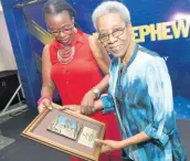  ??  ?? Christene King (left) presents a special award to Carmen Tipling at the PAJ Veterans’ Luncheon on Wednesday.