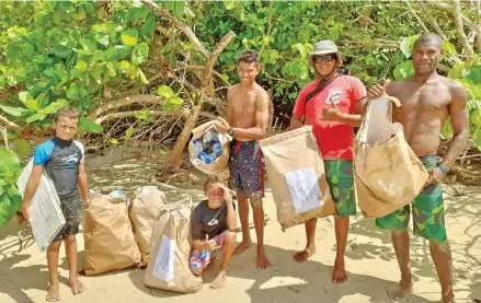  ?? Photo: ?? FijiSurfco members (left) Livai Muller, Niko Muller,Kalama Mckellar, Ratik Chandra and Alipate Ravono clean up at Nanuya lailai island in Yasawa. Ian Ravouvou Muller