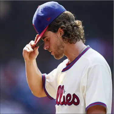  ?? MATT SLOCUM — THE ASSOCIATED PRESS ?? Phillies starting pitcher Aaron Nola walks off the field after the fifth inning in what would prove to be another disappoint­ing outing of a sorry season for him.