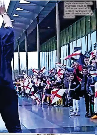  ?? @ENGLAND ?? England manager Gareth Southgate waves to children gathered at St George’s Park to see the team off to the World Cup