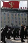  ?? (AP/Jon Chol Jin) ?? North Koreans observe three minutes of silence Friday while facing the portraits of their late leaders Kim Il Sung and Kim Jong Il at the Kim Il Sung Square in Pyongyang, North Korea.
