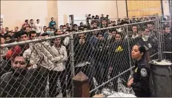  ?? Josh Dawsey / The Washington Post via AP ?? Men stand in a U.S. Immigratio­n and Border Enforcemen­t detention center in Mcallen, Texas, during a July 12, 2019 visit by Vice President Mike Pence. The Biden administra­tion is considerin­g a plan to reinstate immigratio­n detention centers for migrant families.