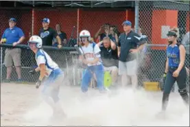  ?? JOHN BREWER - ONEIDA DAILY DISPATCH ?? Oneida first baseman Sydney Lusher, middle, exclaims in celebratio­n after teammate Brianna Laureti slides safely home to tie Saturday’s Section III Class B semifinal tilt 5-5.