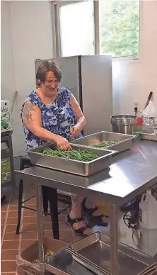  ?? TOM DAYKIN / MILWAUKEE JOURNAL SENTINEL ?? Mary Aprahamian works on preparing some green beans to pickle at Dave’s Famous Pickles, Peppers and Jams.