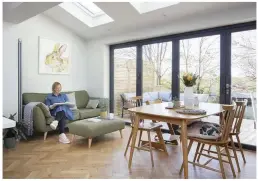  ??  ?? Install skylights to flood a room with light, as Sara and Lucy have in the dining and seating area – the sofa and footstool make it the perfect chill-out space