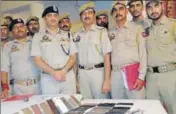  ??  ?? Police officials displaying the seized mobile phones during a press conference in Katra on Friday. HT PHOTO