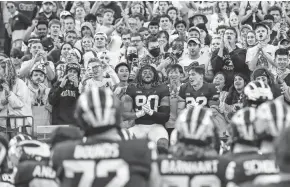  ?? JUNFU HAN VIA IMAGN CONTENT SERVICES, LLC ?? Michigan players sing their fight song at the student section after defeating Rutgers 20-13 in Ann Arbor last Saturday.