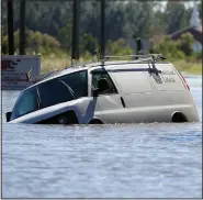  ?? (File Photo/AP/The Goldsboro News-Argus/Casey Mozingo) ?? An abandoned vehicle sits in floodwater caused by Hurricane Matthew on Oct. 10, 2016, at the intersecti­on of John and Benton streets in Goldsboro.