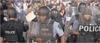  ?? IMAGES SCOTT OLSON, GETTY ?? Police are deployed in St. Louis on Saturday night as demonstrat­ors protest the acquittal of former St. Louis police officer Jason Stockley.