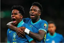  ?? — AFP photos ?? Endrick (left) celebratin­g with Brazil’s midfielder Vinicius Jr after scoring the opening goal of their internatio­nal friendly match against England at the Wembley Stadium.