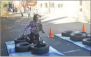  ??  ?? Maddie Lawrence crushes the obstacle course Tuesday at Lake Avenue Elementary School.