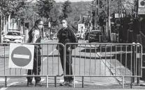  ?? Michel Euler / Associated Press ?? French police officers on Saturday block the access next to the police station where an officer was stabbed to death Friday in Rambouille­t, southwest of Paris.