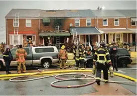  ?? JERRY JACKSON /BALTIMORE SUN ?? Firefighte­rs investigat­e the fire in Dundalk.