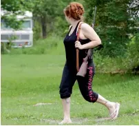  ?? AP ?? Jennifer Hilchey-Reyell watches the tree line as she carries a .22 rifle walking from her mother’s house to her own house near Dannemora. Hilchey-Reyell has been keeping a gun close at hand since the escape of two prisoners from the maximum-security...