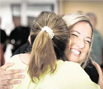  ?? ALIE SKOWRONSKI askowronsk­i@miamiheral­d.com ?? Melinda De La Vega. right, hugs someone after being named an interim council member at a Hialeah City Council meeting on Tuesday at Hialeah City Hall. She will fill the vacancy until a special election is held in November 2025.